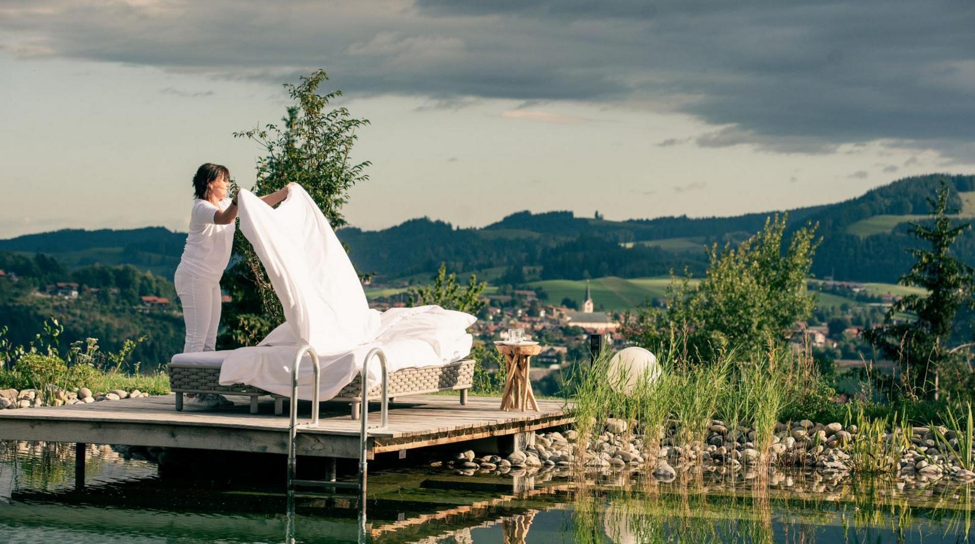 Mitarbeiterin bereitet Schrothpackung für Gäste am Naturschwimmteich vor